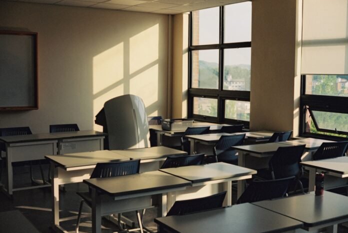 best-itsm-tools-for-education-featured Empty classroom bathed in sunlight through the windows.