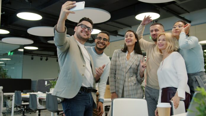 what-does-itsm-stand-for-and-how-does-it-work-featured Group of colleagues taking a selfie in the office.