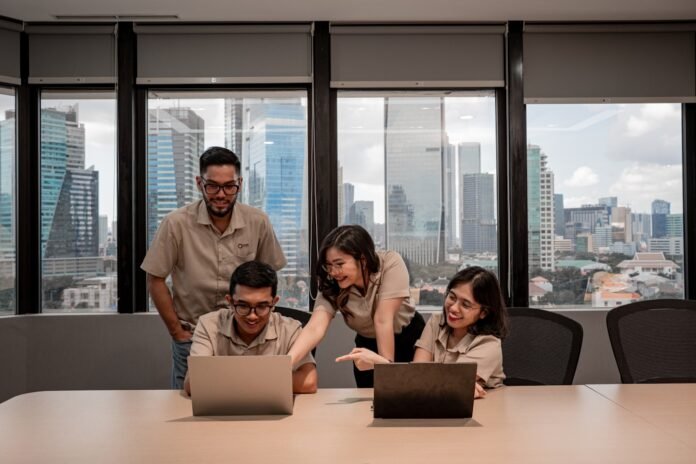 ai-use-cases-in-itsm-featured Team collaborating on laptops in modern office