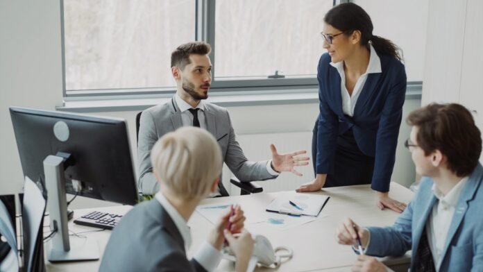 itsm-vs-itil-featured Business professionals collaborating in a modern office meeting.