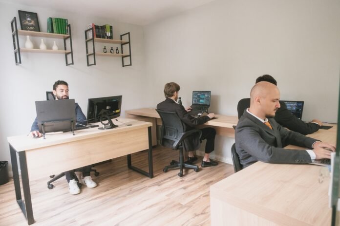 major-incident-management-process-featured Men working on computers in a modern office.