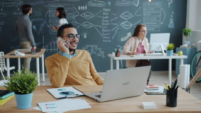 raci-matrix-itsm-featured Man talking on phone in modern office with team